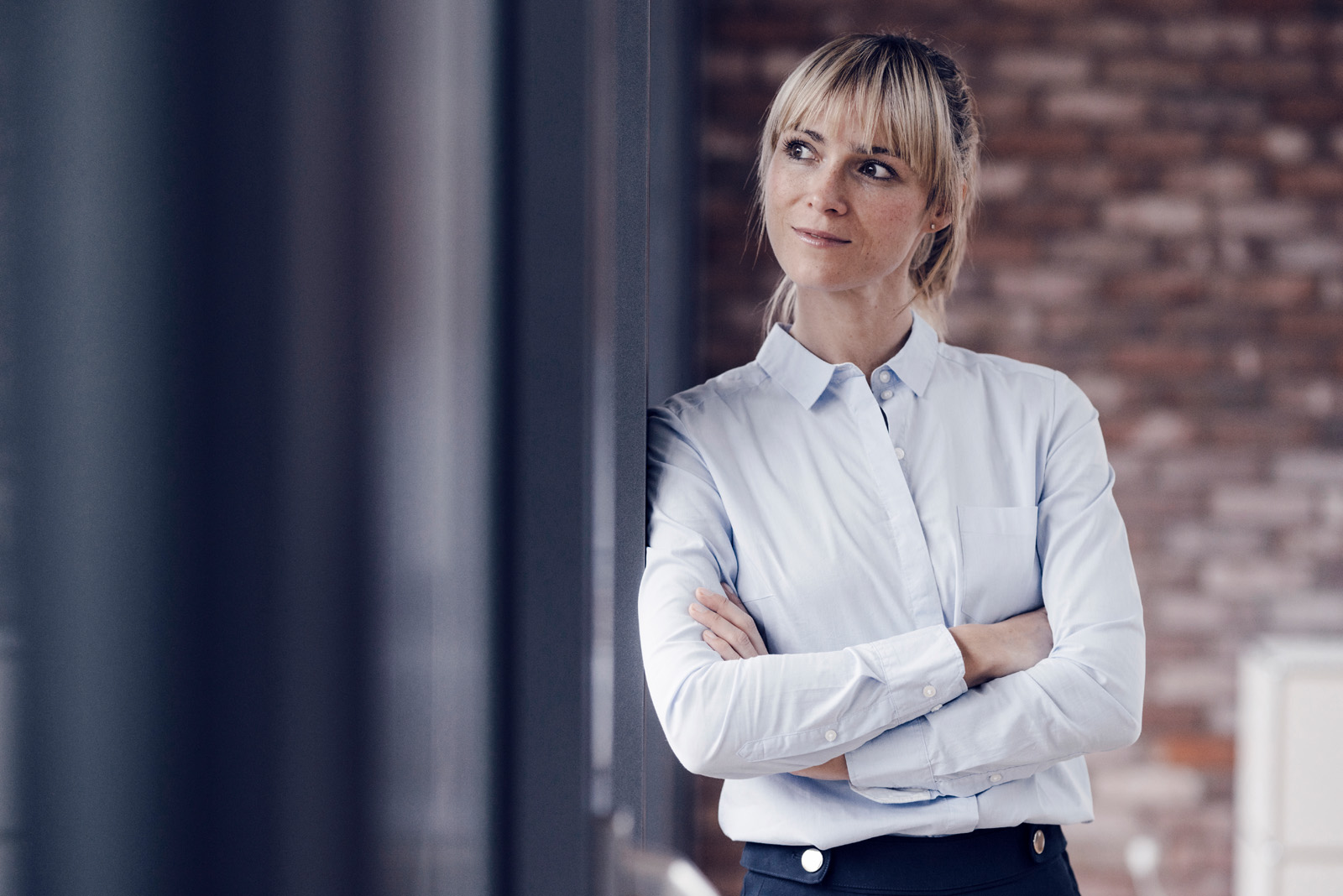 Portrait of a blond businesswoman with arms crossed