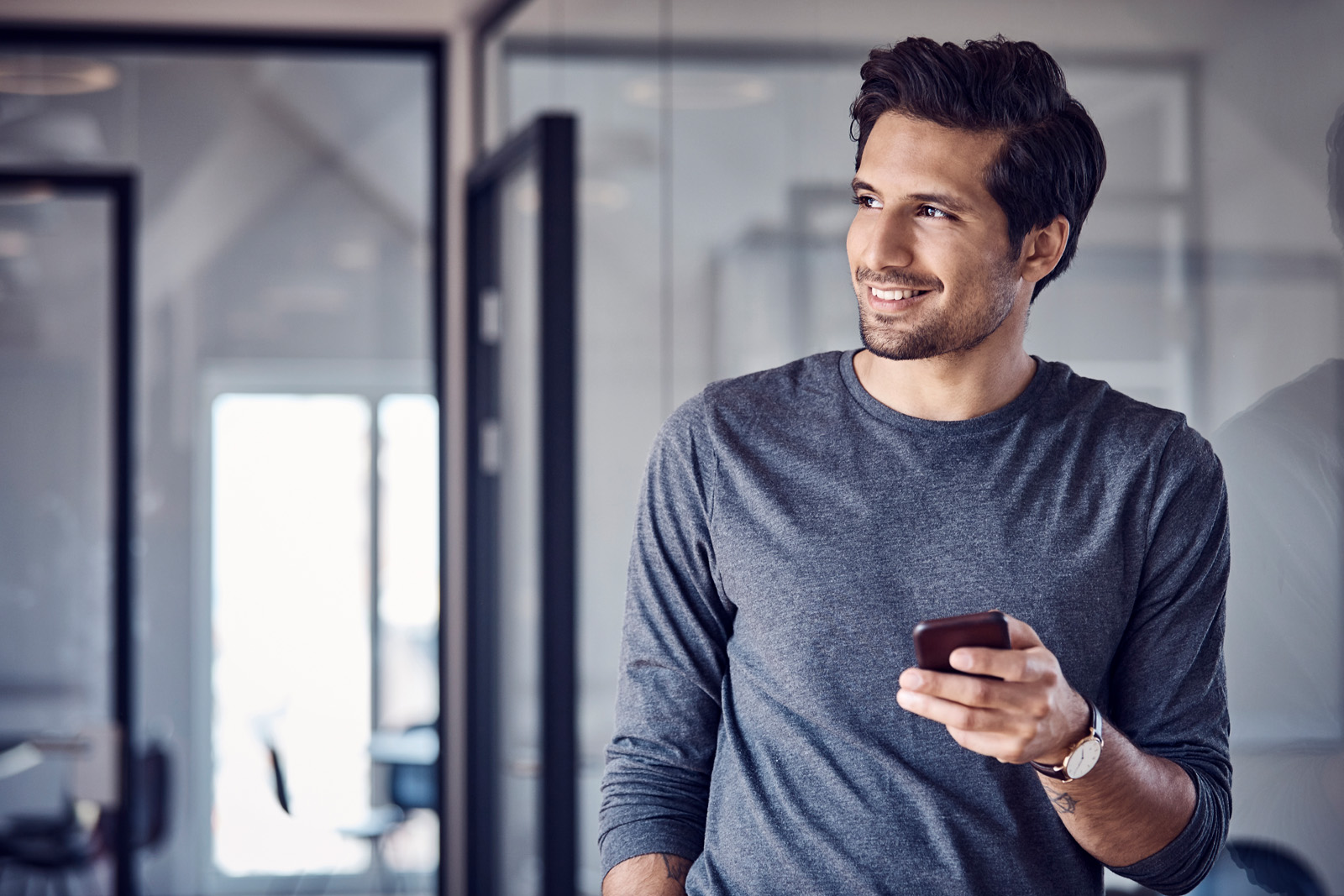 Smiling businessman with mobile phone